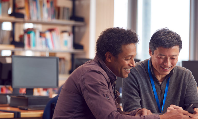 Two male teachers in classroom meeting