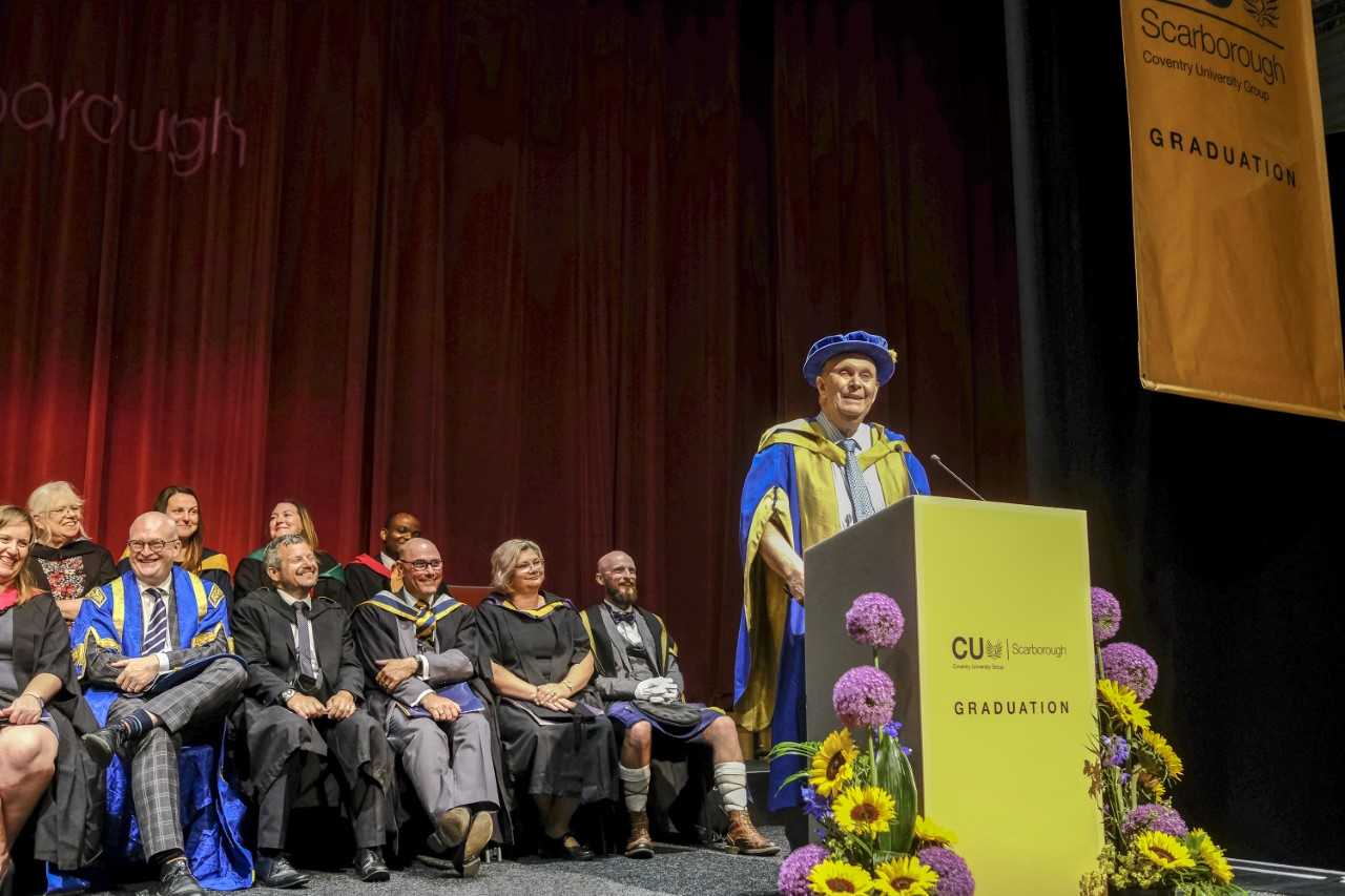 Male speaker speaking in a hall