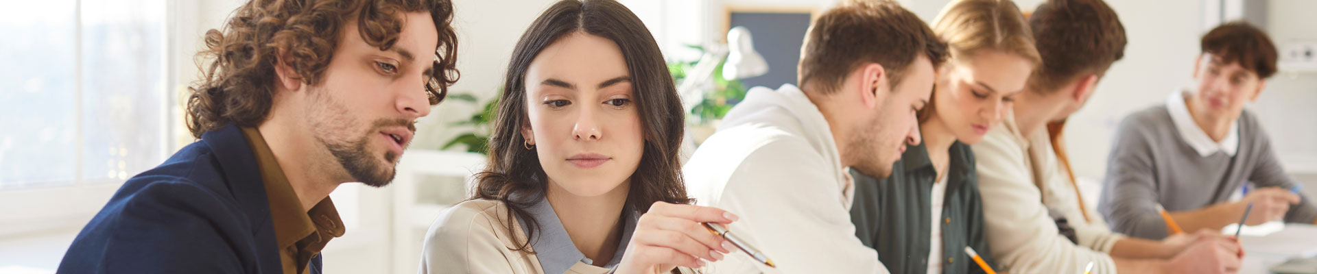 group of people around a table talking and researching